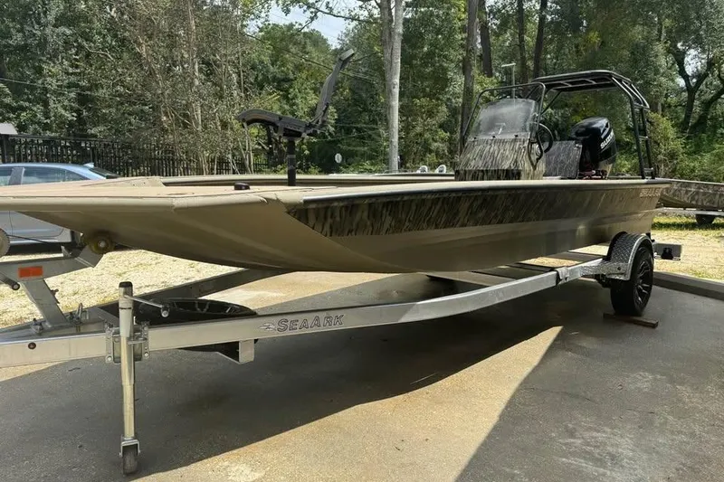 Slide: The Image of 2025 SeaArk Slayer Pro boat on trailer, parked outdoors. - 19