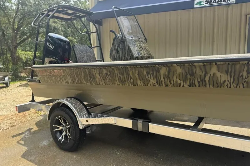 Slide: The Image of 2025 SeaArk Slayer Pro boat on trailer, camo design, Suzuki motor, parked outdoors. - 3
