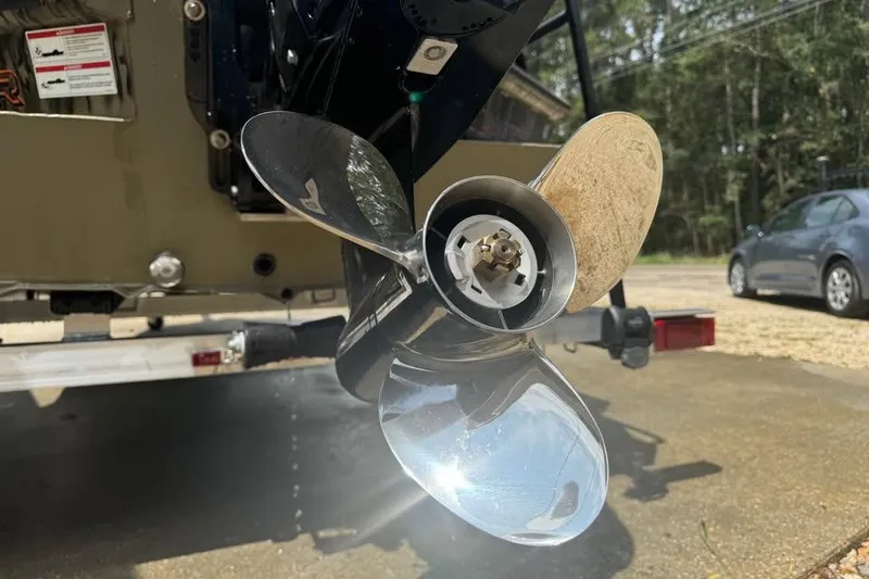 Slide: The Image of Close-up of a 2025 SeaArk Slayer Pro boat propeller, reflecting sunlight. - 8