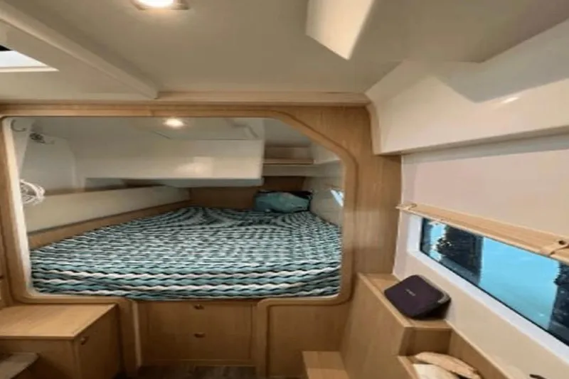 Slide: The Image of Interior cabin of 2022 Aquila 36 Cruiser with cozy bed and window view. - 14