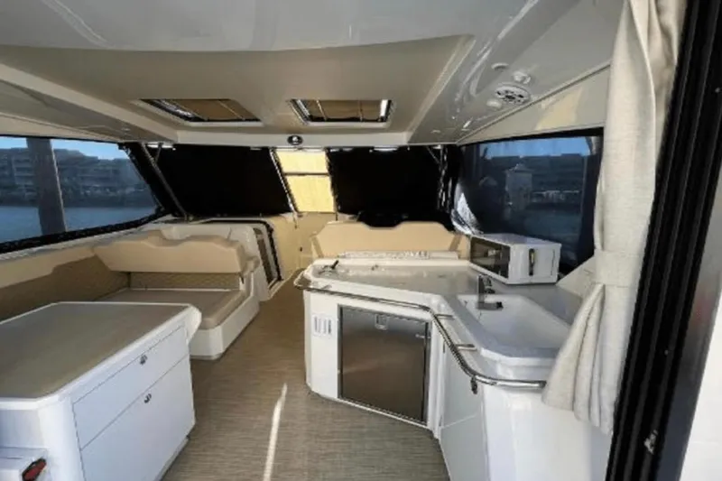 Slide: The Image of Interior of 2022 Aquila 36 Cruiser, featuring modern kitchen and seating area. - 15