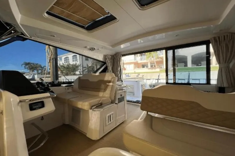 Slide: The Image of Interior of 2022 Aquila 36 Cruiser yacht, featuring luxurious seating and panoramic windows. - 17