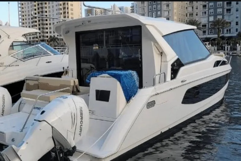 Slide: The Image of Aquila 36 Cruiser 2022 docked, featuring sleek design and powerful Mercury engines. - 4