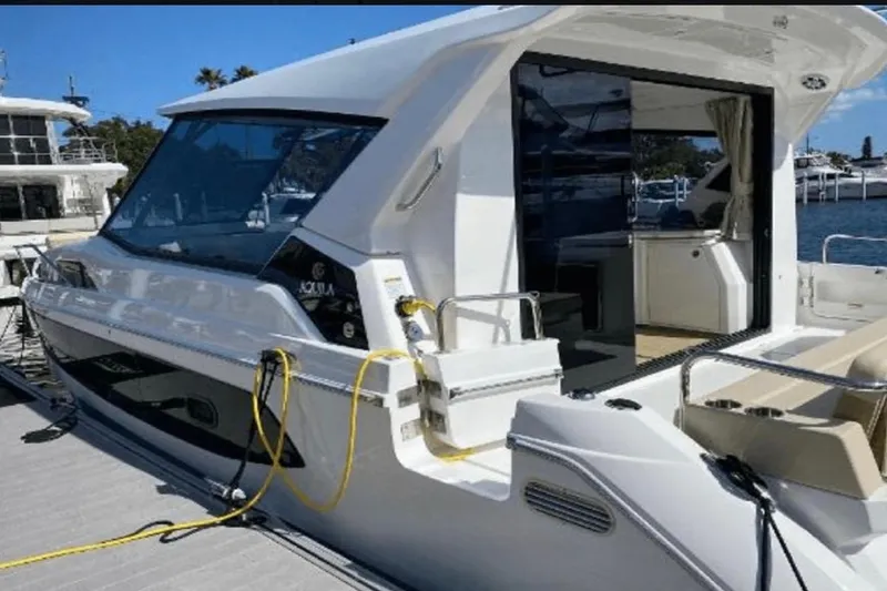 Slide: The Image of Aquila 36 Cruiser 2022 docked, showcasing sleek design and modern features. - 5
