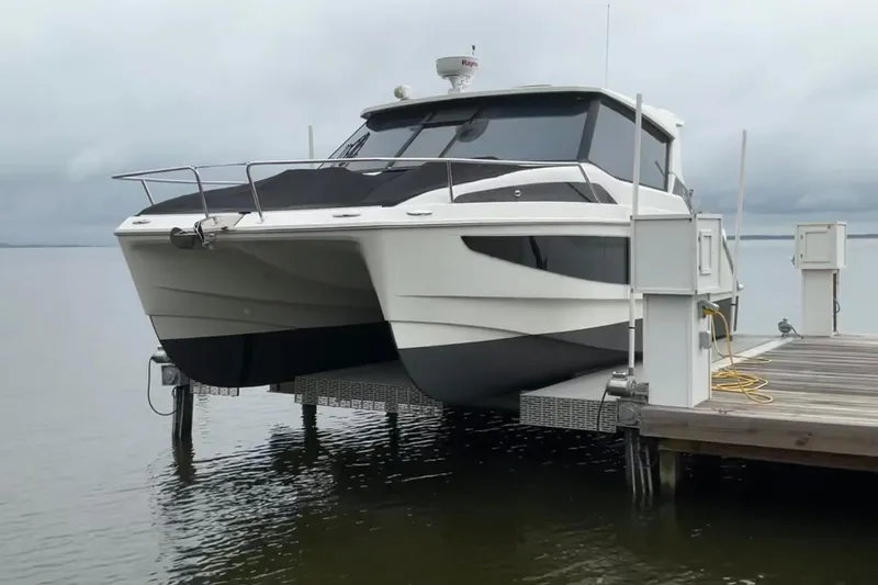 Slide: The Image of Aquila 36 Cruiser 2022 catamaran docked on a lift by the water. - 8