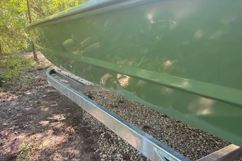 Slide: The Image of 2026 SeaArk 2672 MV boat on trailer, green hull, outdoor setting. - 13