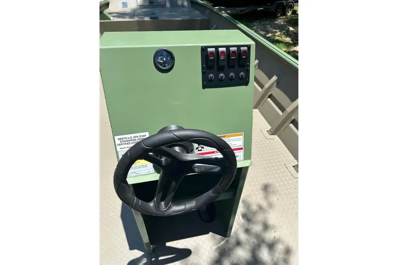 Slide: The Image of 2026 SeaArk 2672 MV boat console with steering wheel and control panel. - 4