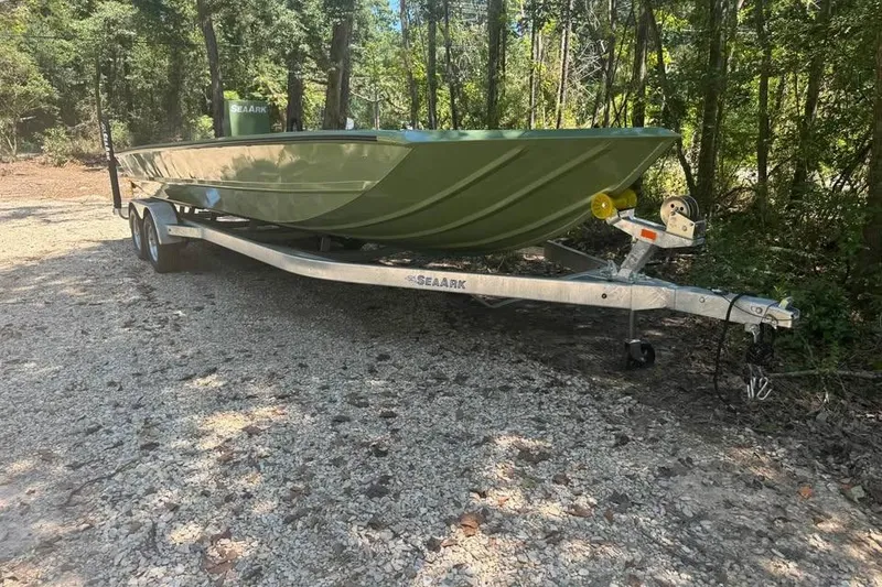 Slide: The Image of 2026 SeaArk 2672 MV boat on trailer in wooded area. - 5