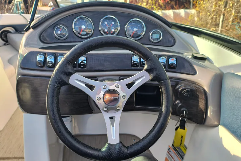 Slide: The Image of Steering wheel and dashboard of 2018 Rinker QX23 BR boat. - 15