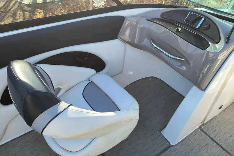 Slide: The Image of 2018 Rinker QX23 BR boat interior with sleek seating and modern dashboard design. - 17