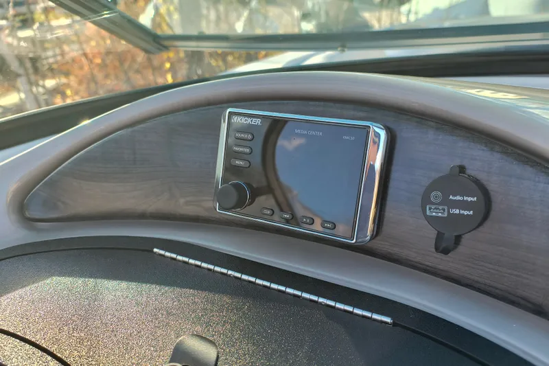 Slide: The Image of 2018 Rinker QX23 BR dashboard with Kicker media center and audio input. - 18