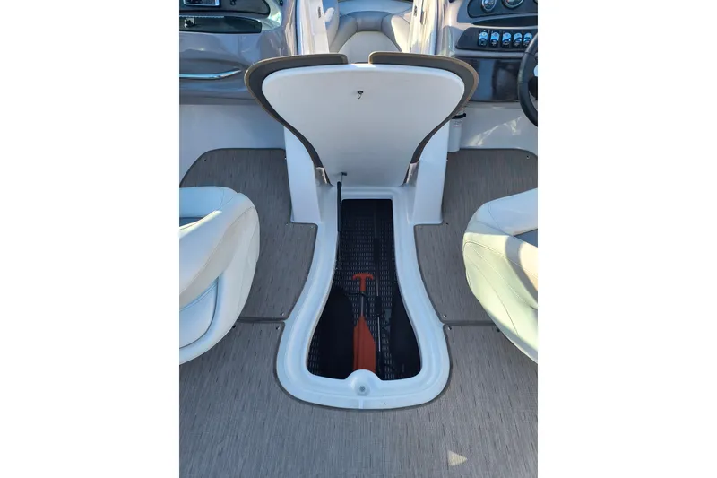 Slide: The Image of 2018 Rinker QX23 BR boat interior storage compartment with open hatch. - 20