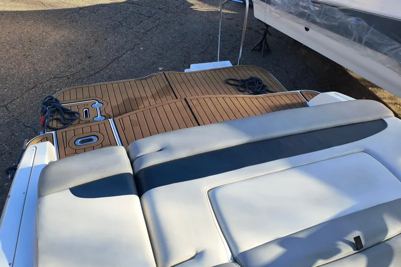 Slide: The Image of 2018 Rinker QX23 BR boat with teak deck and cushioned seating. - 23