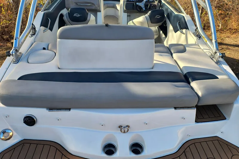 Slide: The Image of 2018 Rinker QX23 BR boat interior with cushioned seating and sleek design. - 25