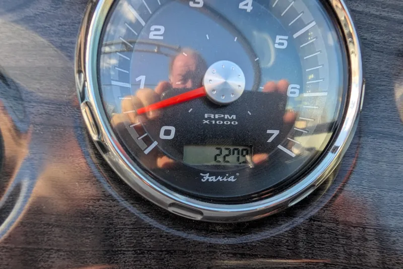 Slide: The Image of Close-up of 2018 Rinker QX23 BR tachometer showing 220 hours. - 30