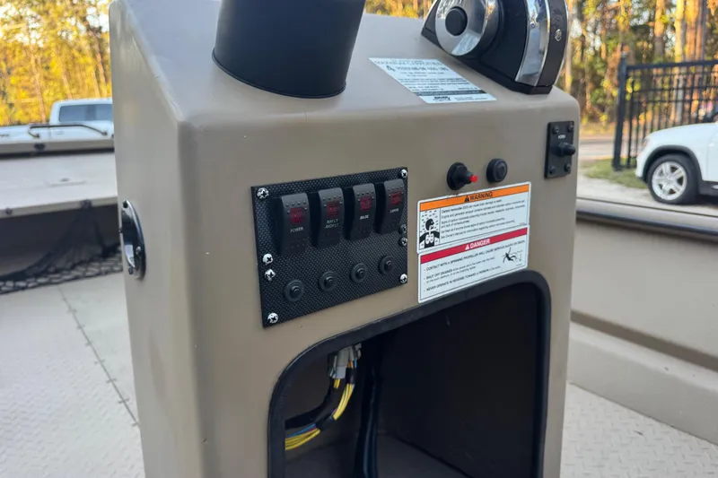 Slide: The Image of Control panel of 2025 SeaArk Mud Runner 180 boat with switches and warning labels. - 11