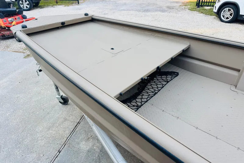 Slide: The Image of 2025 SeaArk Mud Runner 180 boat interior with storage compartment and netting. - 26