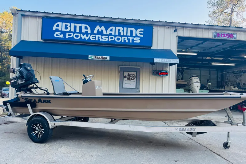 Slide: The Image of 2025 SeaArk Mud Runner 180 boat on trailer at Abita Marine & Powersports dealership. - 4