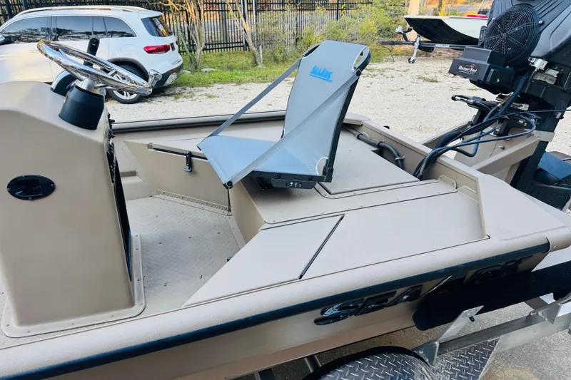 Slide: The Image of 2025 SeaArk Mud Runner 180 boat interior with steering wheel and seating. - 9
