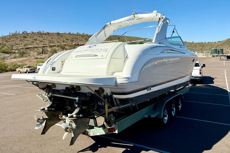 The Image of 2004 Formula 400 Super Sport boat on trailer in sunny parking lot. - 0