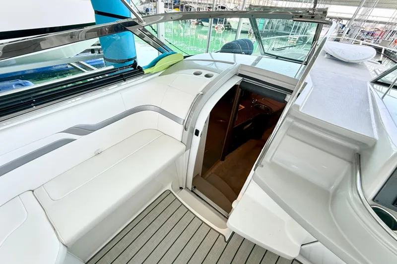 Slide: The Image of 2004 Formula 400 Super Sport yacht interior with white seating and open cabin door. - 12