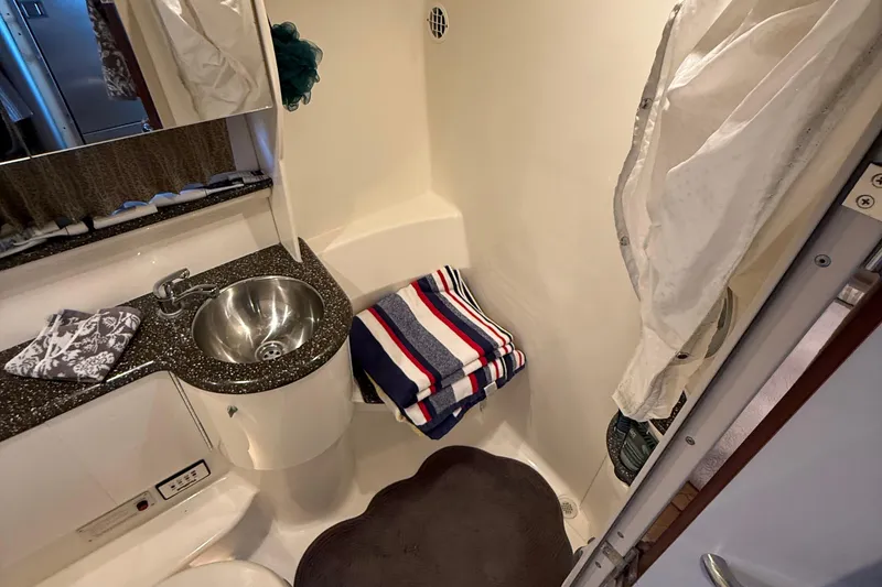 Slide: The Image of 2004 Formula 400 Super Sport bathroom with sink, striped towel, and shower area. - 19