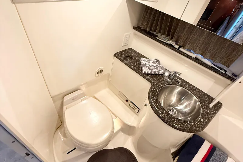 Slide: The Image of 2004 Formula 400 Super Sport yacht bathroom with sink, toilet, and countertop. - 21