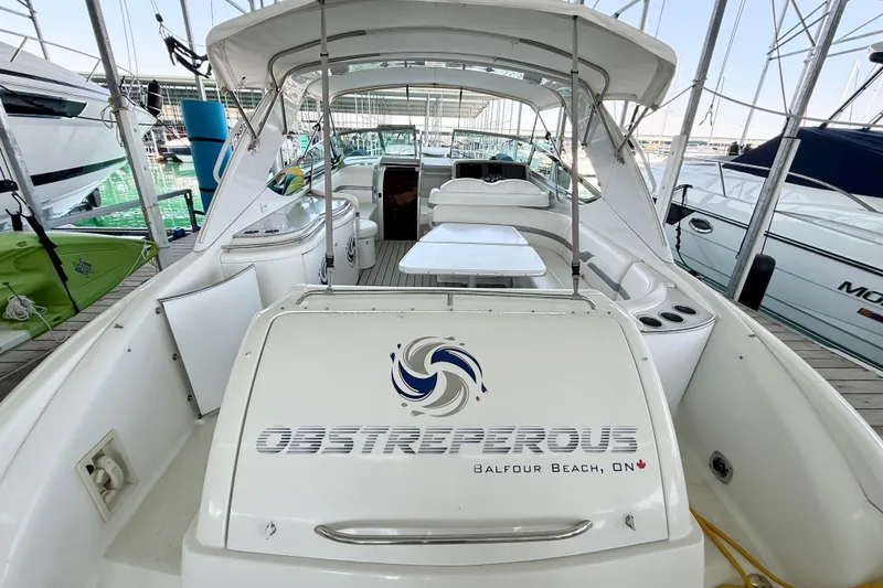 Slide: The Image of 2004 Formula 400 Super Sport boat docked, featuring spacious seating and sleek design. - 31