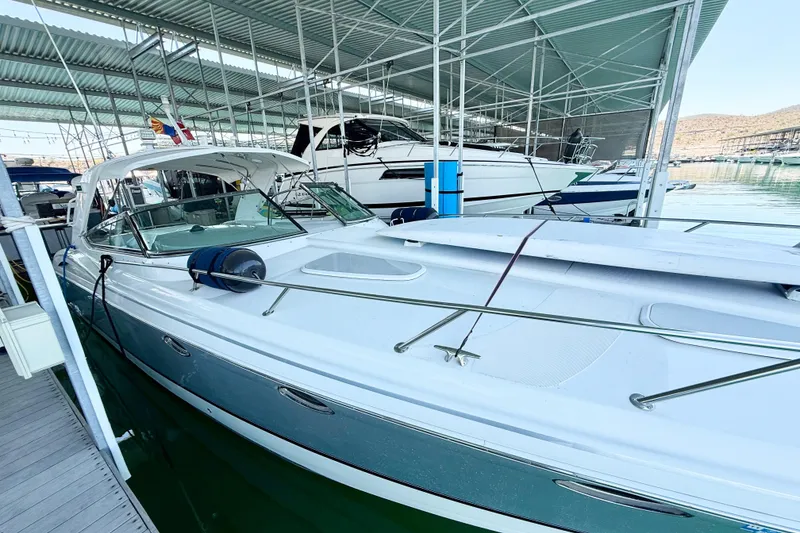 Slide: The Image of 2004 Formula 400 Super Sport boat docked in a marina under a covered structure. - 4