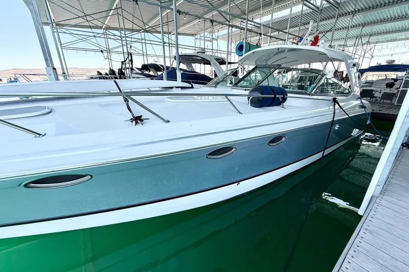 Slide: The Image of 2004 Formula 400 Super Sport boat docked in a marina under a covered structure. - 6