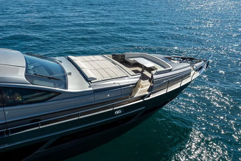 Slide: The Image of 2019 Pershing 9X yacht cruising on sparkling blue ocean waters. - 10