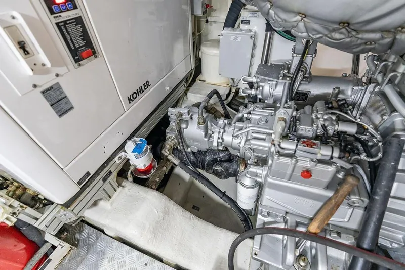 Slide: The Image of Engine room of 2019 Pershing 9X yacht featuring Kohler generator and mechanical components. - 102