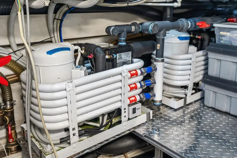 Slide: The Image of Engine room of 2019 Pershing 9X yacht with cooling systems and piping. - 103