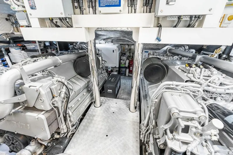 Slide: The Image of Engine room of a 2019 Pershing 9X yacht, showcasing advanced machinery and equipment. - 108