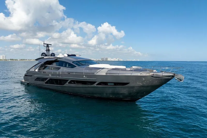 Slide: The Image of 2019 Pershing 9X luxury yacht cruising on open sea under clear blue sky. - 2