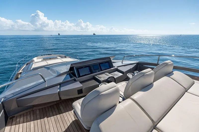 Slide: The Image of Luxurious 2019 Pershing 9X yacht deck with ocean view and modern controls. - 22