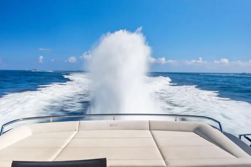Slide: The Image of 2019 Pershing 9X yacht cruising on open sea, leaving a foamy wake. - 33