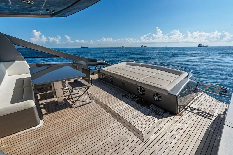 Slide: The Image of Luxurious 2019 Pershing 9X yacht deck with seating, table, and ocean view. - 34