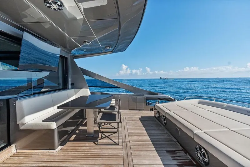 Slide: The Image of Luxurious 2019 Pershing 9X yacht deck with seating, ocean view, and modern design. - 35