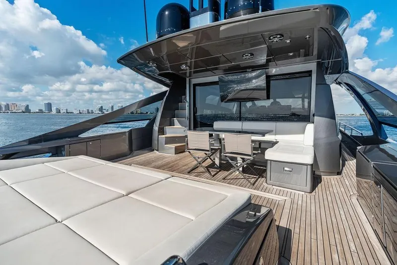 Slide: The Image of Luxurious 2019 Pershing 9X yacht deck with seating, table, and ocean view. - 37