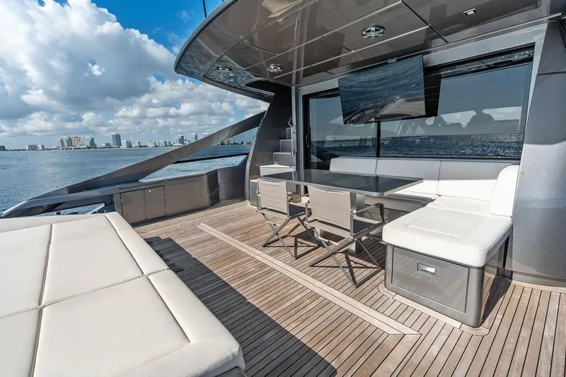 Slide: The Image of Luxurious 2019 Pershing 9X yacht deck with seating, table, and ocean view. - 42