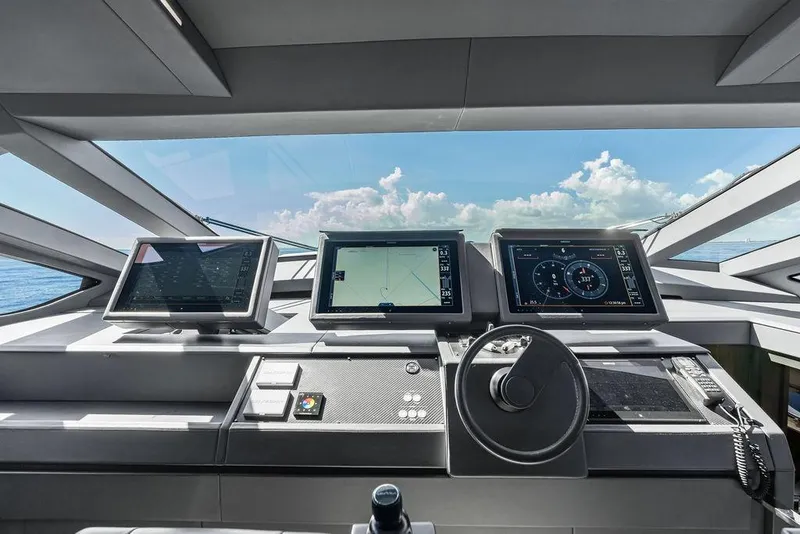 Slide: The Image of Control panel of 2019 Pershing 9X yacht with navigation screens and steering wheel. - 56