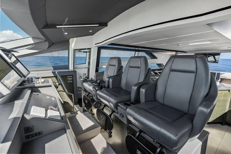Slide: The Image of Luxurious interior of 2019 Pershing 9X yacht with modern helm and leather seating. - 57