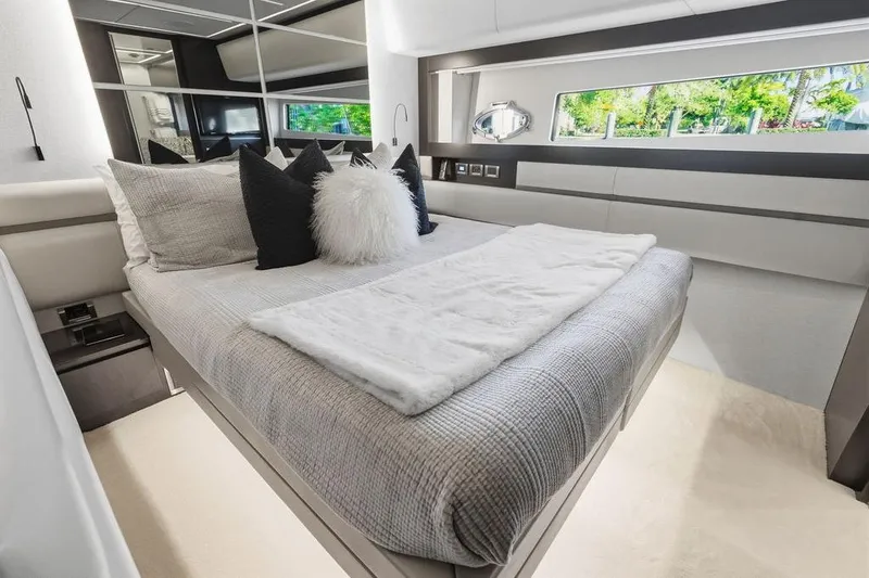 Slide: The Image of Luxurious bedroom interior of 2019 Pershing 9X yacht with modern decor and large window. - 65