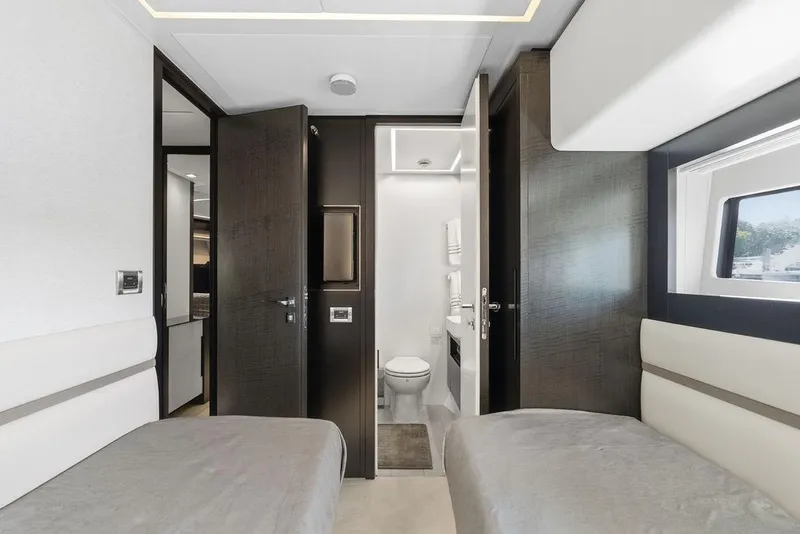 Slide: The Image of Luxurious interior of 2019 Pershing 9X yacht with twin beds and modern bathroom. - 72