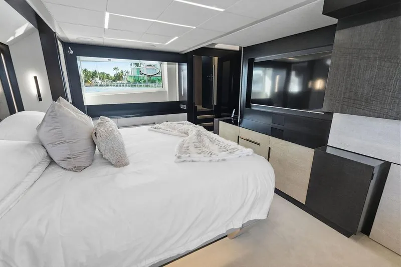 Slide: The Image of Luxurious bedroom interior of 2019 Pershing 9X yacht with modern decor and large window view. - 81