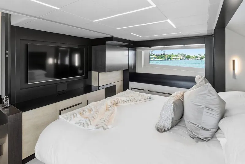 Slide: The Image of Luxurious bedroom interior of 2019 Pershing 9X yacht with modern decor and large window view. - 83