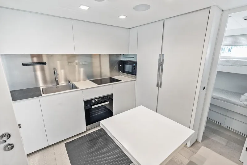 Slide: The Image of Modern kitchen interior of 2019 Pershing 9X yacht with sleek white cabinetry. - 86