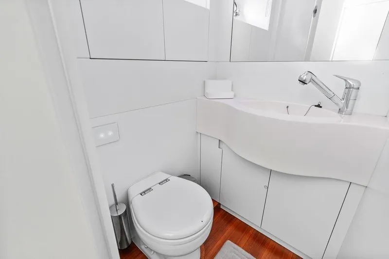 Slide: The Image of Modern bathroom in 2019 Pershing 9X yacht with sleek fixtures and white cabinetry. - 88