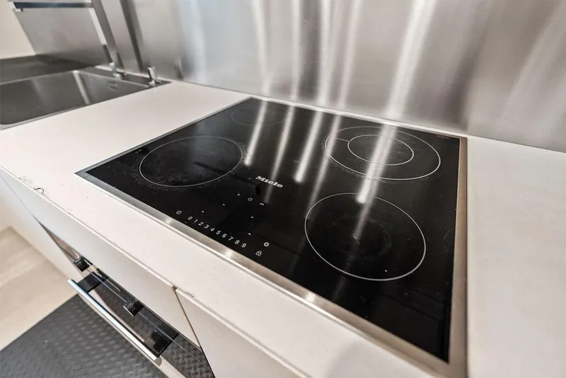 Slide: The Image of Modern kitchen with sleek Miele induction cooktop on Pershing 9X yacht, 2019 model. - 92